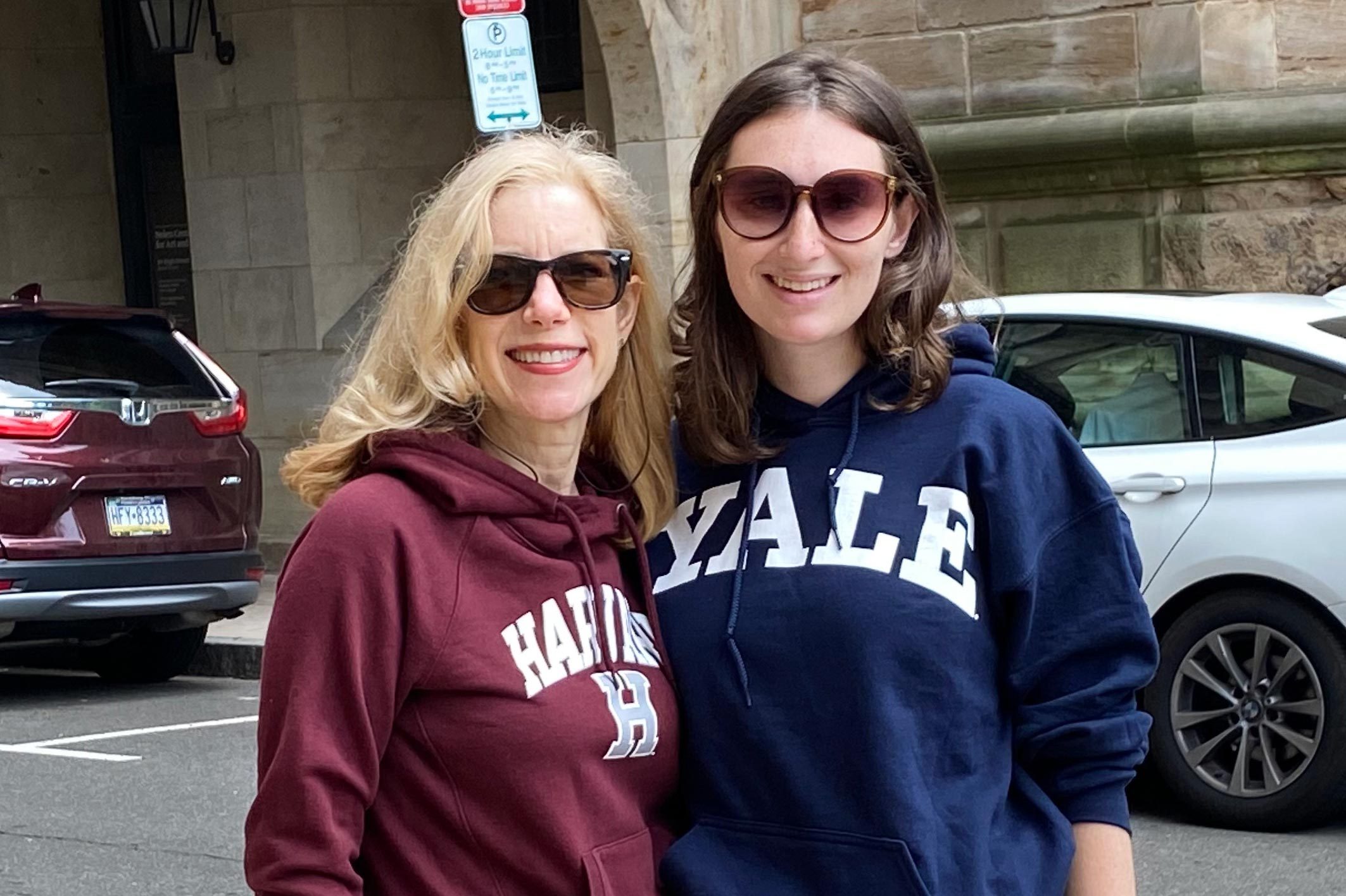 Janice Lintz And Daughter in college sweatshirts, harvard and yale, respectively