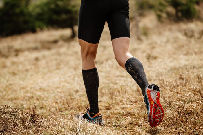 male leg runner in black compression socks