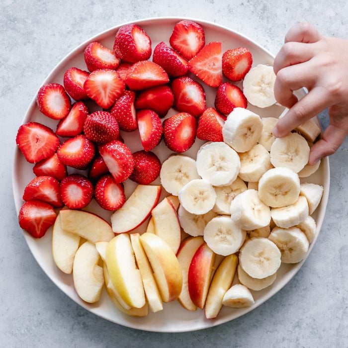 hand reaching for banana on a Fruit snack platter