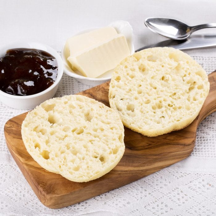 Fresh homemade English muffins with butter and jam