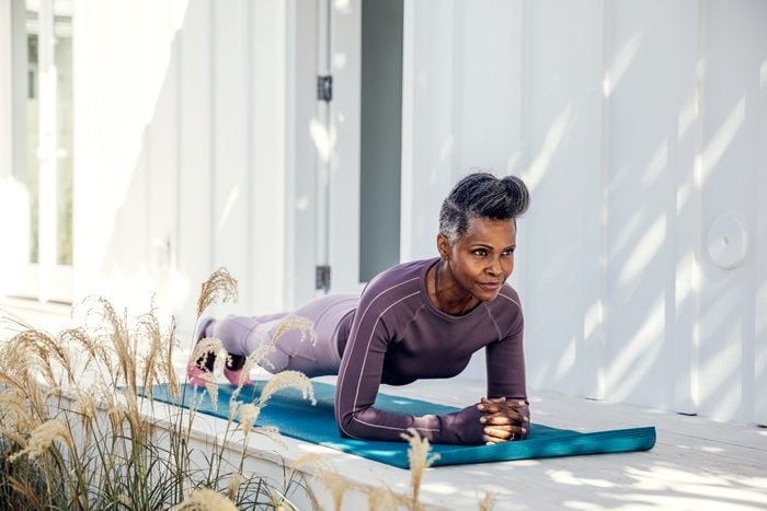 older Woman in plank position on exercise mat