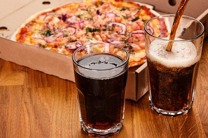Glass of coke and pizza