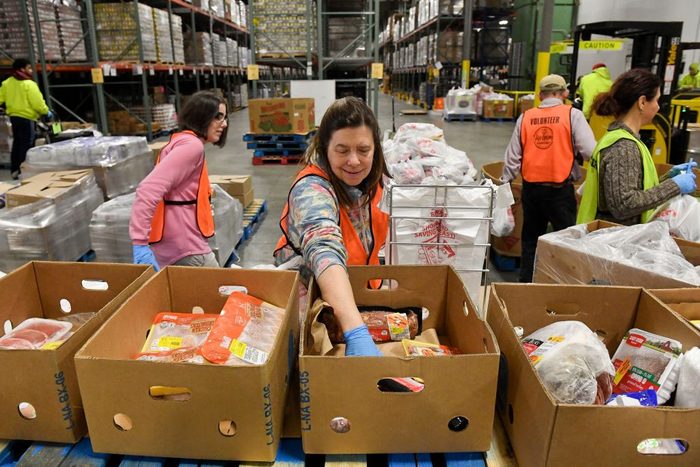 Volunteers Pack Food At Food Bank