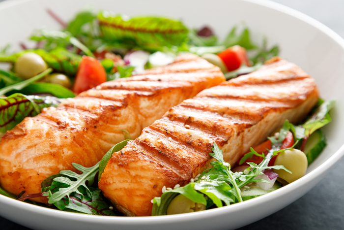 Grilled salmon fillet and fresh vegetable salad. Mediterranean diet.