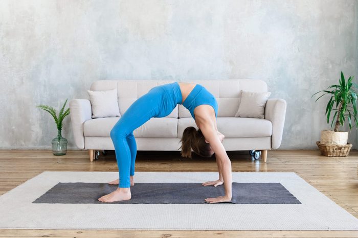 woman doing full wheel yoga pose at home