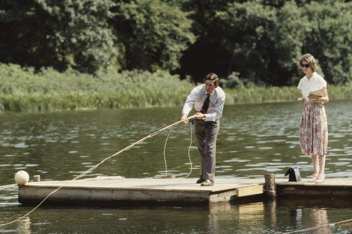 Young King Charles fishing on a dock