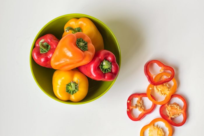 Bowl of fresh bell peppers on white