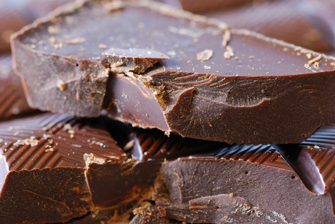 A close up view of some broken pieces of dark chocolate.