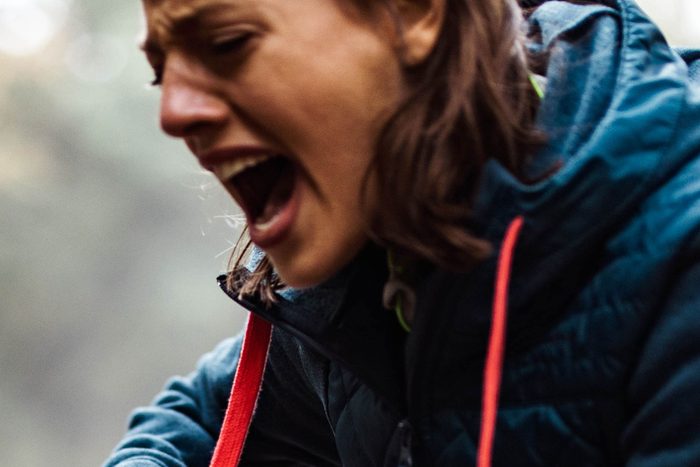 close up of woman screaming outdoors