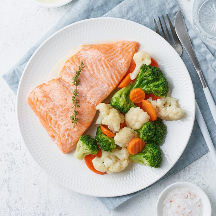 Steam salmon and vegetables on a white plate
