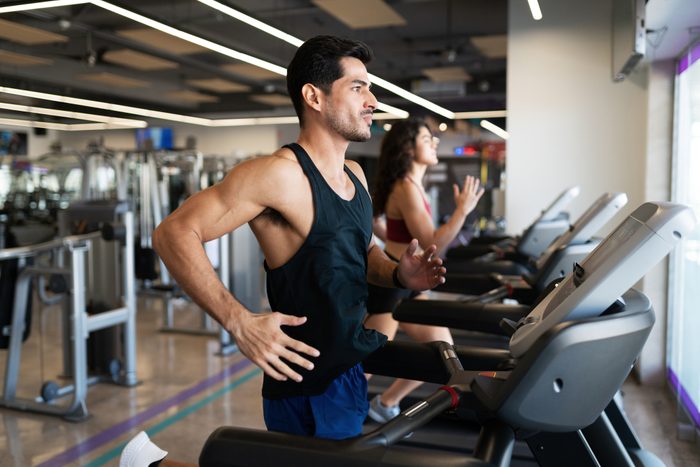 Latin man doing a cardio workout in a treadmill