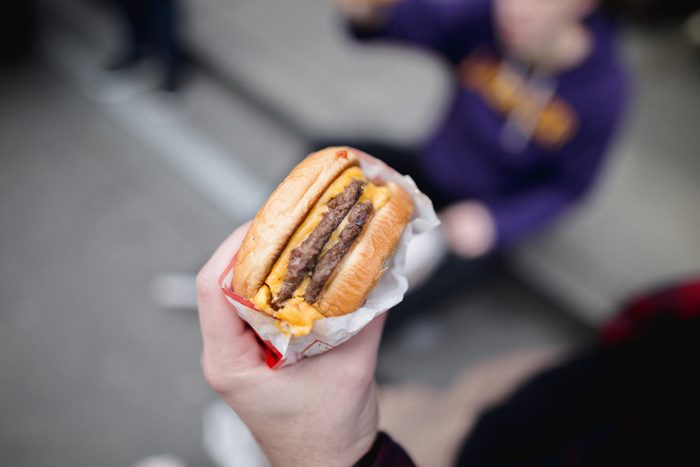 Cropped hand of person holding burger,San Francisco,California,United States,USA