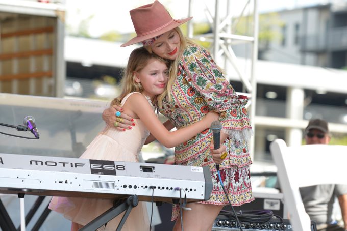 Singer-songwriter, mental health expert Jewel gives Michaela Bryan, 9, and hug after her performance during Keen On Presents, Opening Act on the Fitness Arena stage during the first day of The Wellness Experience by Kroger at The Banks on August 20, 2021 in Cincinnati, Ohio.