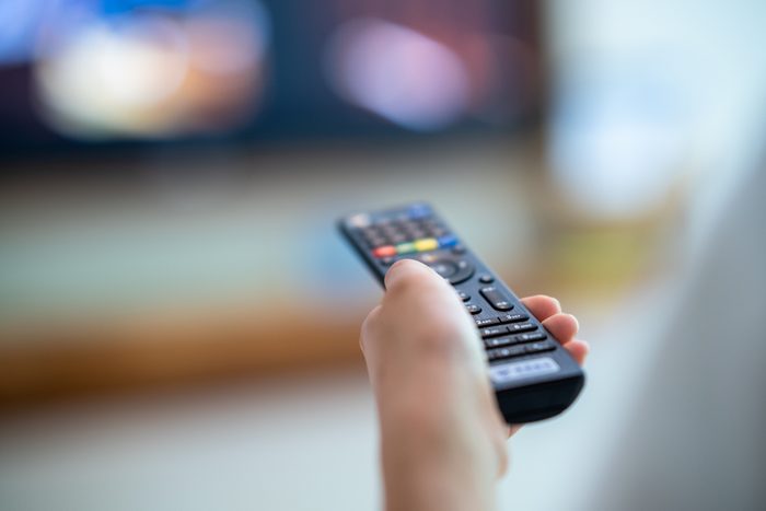remote control with TV selecting a channel to watch