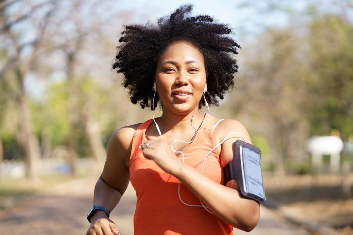 Young woman running exercise wearing heartbeat monitoring and smart watch