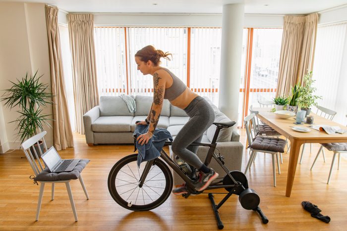 Woman working out on her indoors cycling turbo trainer