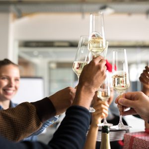 Business people toasting champagne flutes while celebrating Christmas