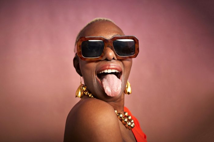 portrait of a woman in sunglasses sticking out her tongue