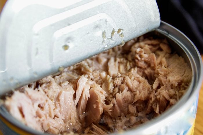 Canned tuna close up with the can peeled half open