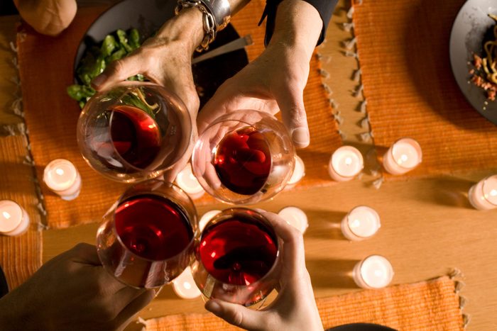 Four Adults Toasting With Red Wine, Overhead View, Close Up Of Hands