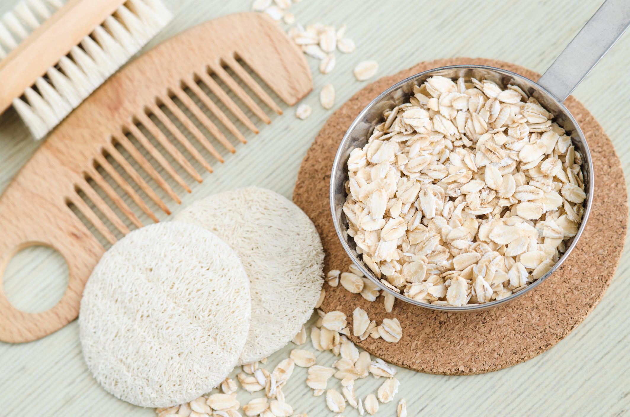 Rolled oats in a small bowl for preparing homemade facial mask and scrub. DIY oatmeal cosmetics.