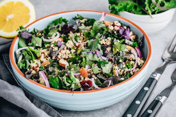 Healthy bowl kale and quinoa salad with cranberry, red onions and almonds