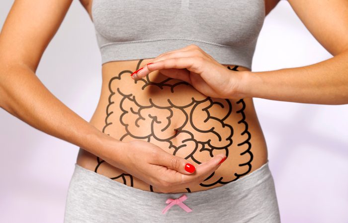 Woman cradles her internal organs and intestines