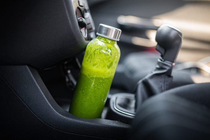 Close-Up Of Green Health Drink In Sustainable Bottle In a car