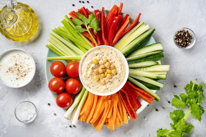 Plate with assorted fresh vegetable sticks with dips