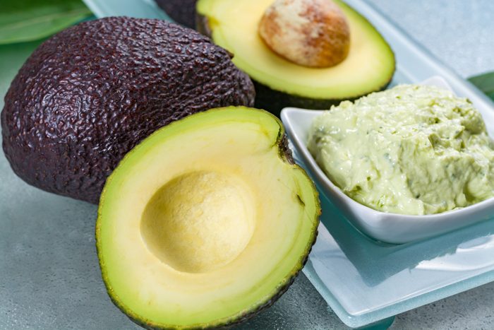 Avocado skin & hair care home spa, ripe avocados and bowl with homemade fresh avocado mask