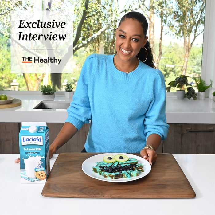portrait of Tia Mowry in the kitchen with a carton of Lactaid and a plate of food she made