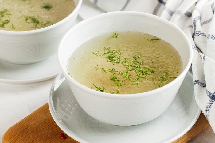 white bowl with clear veggie broth