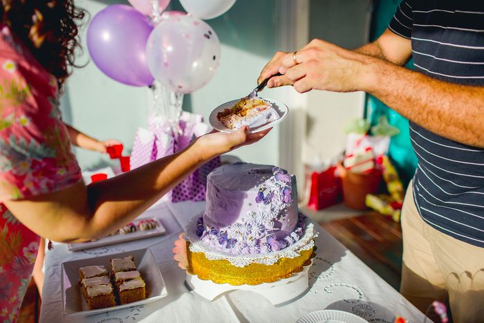 serving a slice of cake at a birthday party
