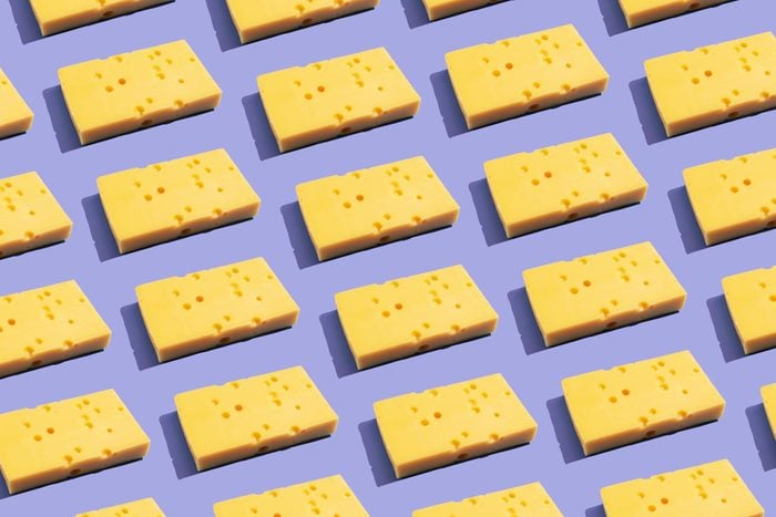 Cheese on the purple background arranged in a grid to fill the frame