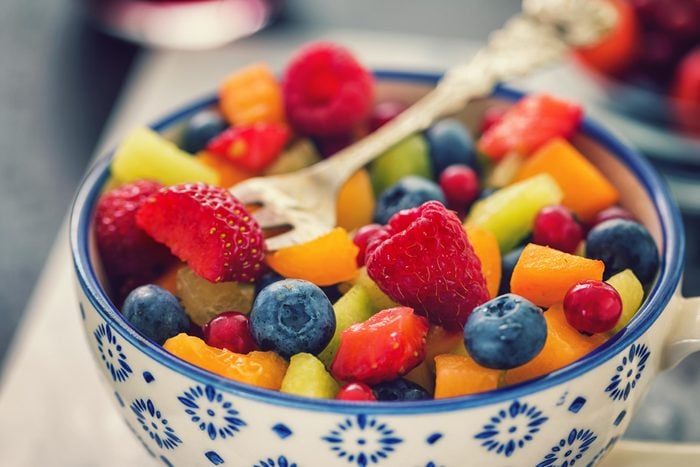 bowl filled with a colorful mixed fruit salad with strawberries, blueberries, Melon and other fruits