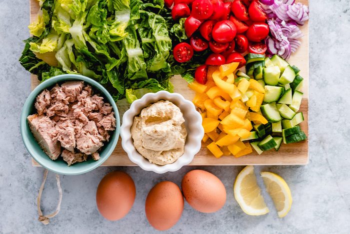 Egg and tuna salad ingredients on a chopping board