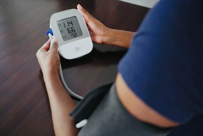 Woman Monitors Her Blood Pressure