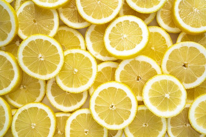 Lemon fruit slices arrangement in a row full frame background