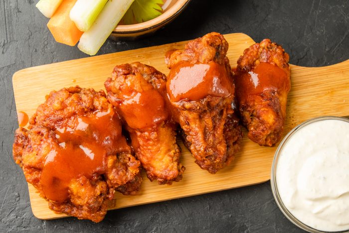 Fried chicken buffalo wings drizzled with sauce