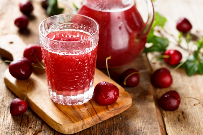 Cherry Horchata with a glass cup decanter and cherries on a wooden background