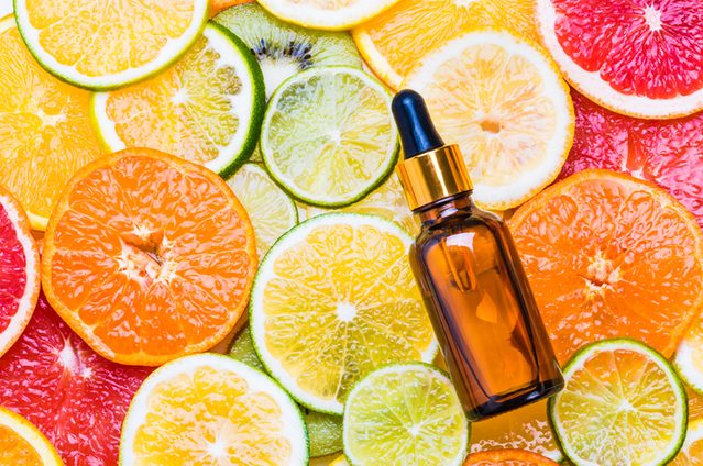 Citrus fruit oil or vitamin c organic cosmetic on citrus background