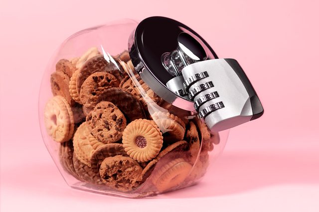 Biscuit Jar With Padlock on a pink background