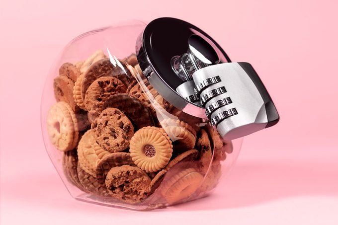 Biscuit Jar With Padlock on a pink background
