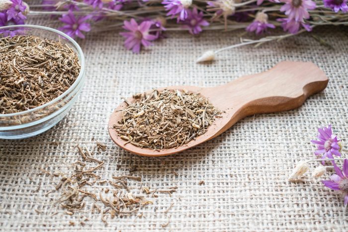 Dried Valerian roots in wooden spoon on sackcloth background. Valeriana officinalis, Caprifoliaceae in herbal medicine. Valerian Root for Anxiety and Sleep. valerian extracts as nutritional supplement for health