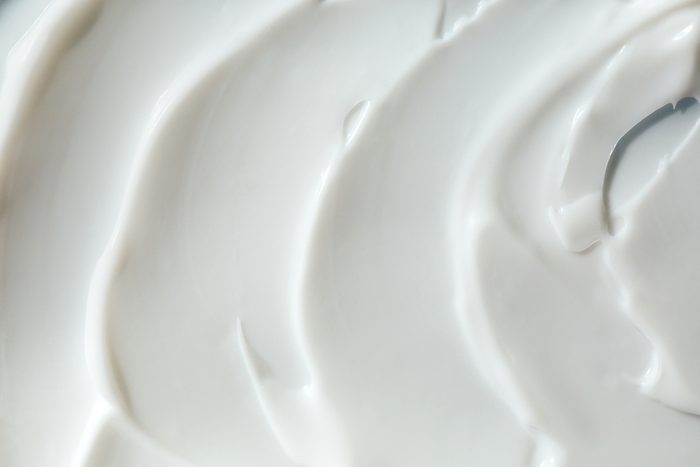 Texture of smears of white yogurt or cream. Good background for your design