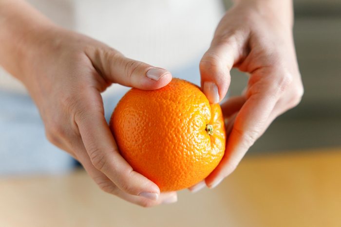 hands Peeling an Orange