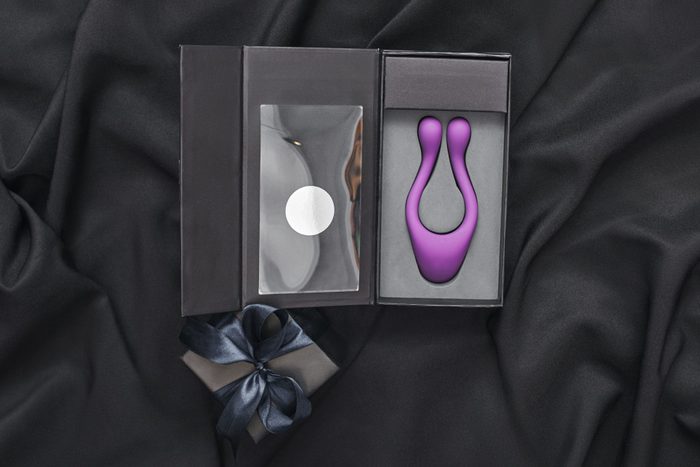 sex toy in a black box on a black silk background