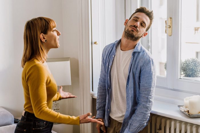Young Couple Arguing While Standing At Home