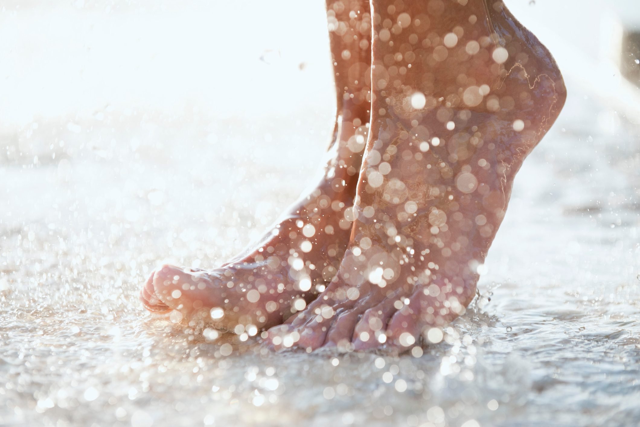 Feet under shower outdoors