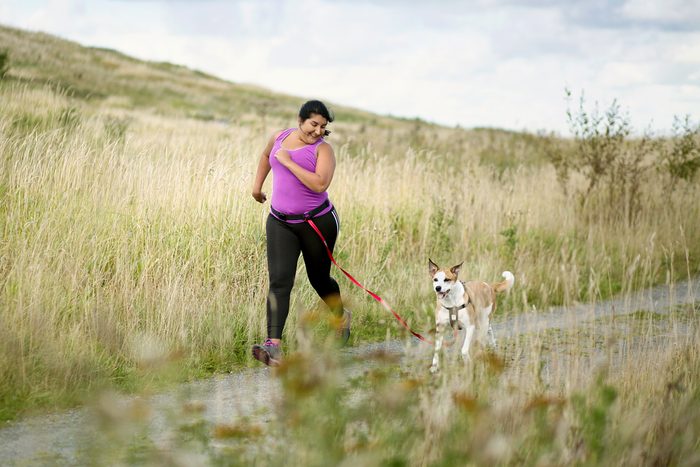 woman running with her dog outside